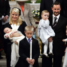 Marius carries the "Christening Candle" out of the Palace Chapel after the ceremony (Photo: Tor Richardsen / Scanpix)